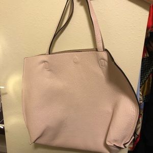 Reversible faux leather tote with wristle.